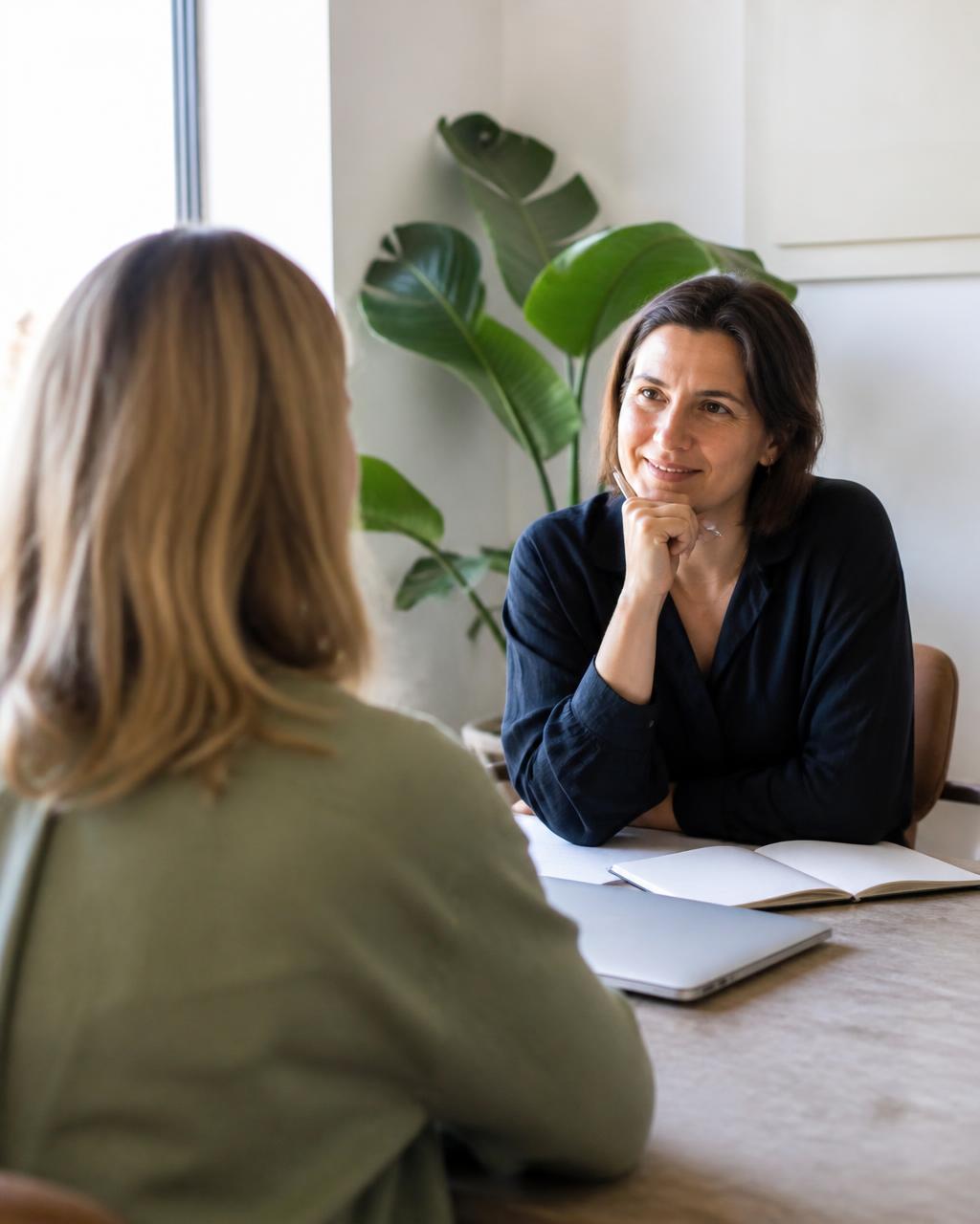 A coach and coachee in conversation across a table